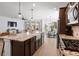 Open-concept kitchen island with stainless steel appliances and an adjacent living and dining area at 347 Ripple Park Dr, Summerville, SC 29486