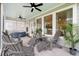 Inviting covered patio with comfortable seating, ceiling fans, and a spa, creating an ideal outdoor retreat at 347 Ripple Park Dr, Summerville, SC 29486