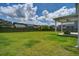 Expansive backyard featuring lush green grass, a wooden fence, and a covered patio with a ceiling fan at 357 Beachgrass Ln, Summerville, SC 29486