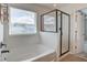 Bathroom featuring a tub and a separate glass shower with natural light from the window at 357 Beachgrass Ln, Summerville, SC 29486