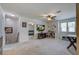 Spacious bonus room with neutral carpeting, ceiling fan and natural lighting, with access to another room at 357 Beachgrass Ln, Summerville, SC 29486