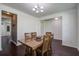 Warm dining room with hardwood floors featuring a wooden table centerpiece, and lots of natural light at 357 Beachgrass Ln, Summerville, SC 29486