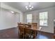 Bright dining room boasts hardwood floors, modern lighting and a large window offering plenty of natural light at 357 Beachgrass Ln, Summerville, SC 29486