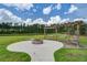 Outdoor fire pit area with swing benches, offering a cozy space for gatherings with beautiful pond views at 357 Beachgrass Ln, Summerville, SC 29486