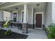 Inviting front porch with rocking chairs, stone accents, and a welcoming entrance at 357 Beachgrass Ln, Summerville, SC 29486