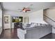 Comfortable living room featuring dark wood floors, a ceiling fan, and a cozy gray sectional at 357 Beachgrass Ln, Summerville, SC 29486