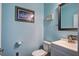 Charming powder room featuring baby blue walls, framed art and a vanity with a mirror at 357 Beachgrass Ln, Summerville, SC 29486