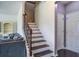 Open staircase with hardwood treads and a dark railing leading to the upper level at 357 Beachgrass Ln, Summerville, SC 29486