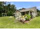 Spacious backyard with a screened-in porch, fire pit, and lush greenery at 3789 Tupelo Branch Row, Mount Pleasant, SC 29429