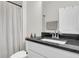 Well-lit bathroom featuring a granite countertop vanity, shower, and modern fixtures at 3789 Tupelo Branch Row, Mount Pleasant, SC 29429