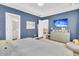 Stylish bedroom with a dresser, mounted TV, and ample natural light from large windows at 3789 Tupelo Branch Row, Mount Pleasant, SC 29429