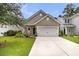 Charming home with a well-manicured lawn, flower beds, and a two-car garage at 3789 Tupelo Branch Row, Mount Pleasant, SC 29429