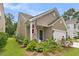 Charming home with manicured lawn, flower beds, and a rocking chair on the covered front porch at 3789 Tupelo Branch Row, Mount Pleasant, SC 29429