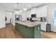 Bright kitchen with island, stainless steel appliances, and modern finishes is perfect for cooking and entertaining at 3789 Tupelo Branch Row, Mount Pleasant, SC 29429