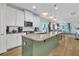 Bright open kitchen featuring granite countertops, stainless steel appliances, and an island overlooking the living area at 3789 Tupelo Branch Row, Mount Pleasant, SC 29429