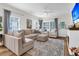 Spacious living room with fireplace, comfortable seating, and large windows for natural light at 3789 Tupelo Branch Row, Mount Pleasant, SC 29429