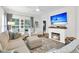 Cozy living room with a fireplace, comfortable furniture, and a bright, inviting atmosphere at 3789 Tupelo Branch Row, Mount Pleasant, SC 29429