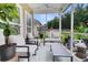 Cozy screened-in patio featuring comfortable seating, plants, and a view of the backyard at 3789 Tupelo Branch Row, Mount Pleasant, SC 29429