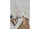 Bright stairway with white railings, wood steps, a pendant light, and a window with natural light at 3789 Tupelo Branch Row, Mount Pleasant, SC 29429