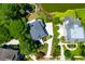 Aerial view of a home with nice landscaping, a lake, a long driveway, and is surrounded by mature trees at 391 Evian Way, Mount Pleasant, SC 29464