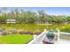 Scenic backyard view showcasing a grill, lush greenery, and a tranquil pond at 391 Evian Way, Mount Pleasant, SC 29464