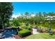 Beautiful backyard with fire pit, lush landscaping, and tranquil water view at 391 Evian Way, Mount Pleasant, SC 29464