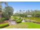 Scenic backyard with lush greenery, fire pit, and serene lake views, perfect for outdoor enjoyment at 391 Evian Way, Mount Pleasant, SC 29464