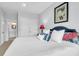 Bedroom features a plush bed with decorative pillows, and artwork and a doorway view to the bathroom at 391 Evian Way, Mount Pleasant, SC 29464