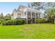 Charming, multi-story home featuring manicured landscaping and inviting outdoor spaces and rear yard at 391 Evian Way, Mount Pleasant, SC 29464