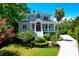 Charming two-story home with a red door, white stairs, nicely landscaped yard, and a long driveway at 391 Evian Way, Mount Pleasant, SC 29464