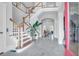 Grand foyer featuring hardwood stairs, a large plant, and an open floor plan at 391 Evian Way, Mount Pleasant, SC 29464