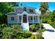 Charming front exterior with a red door, inviting porch, and well-manicured landscaping at 391 Evian Way, Mount Pleasant, SC 29464
