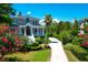 Gorgeous front exterior with lush landscaping and a circular driveway at 391 Evian Way, Mount Pleasant, SC 29464