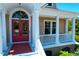 Inviting front porch with a red door and white columns, perfect for relaxing at 391 Evian Way, Mount Pleasant, SC 29464
