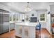 Bright kitchen with white cabinets, a central island, and modern stainless steel appliances at 391 Evian Way, Mount Pleasant, SC 29464
