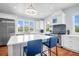 Bright kitchen featuring white cabinets, a large island with barstool seating, and stainless steel appliances at 391 Evian Way, Mount Pleasant, SC 29464