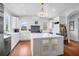 Beautiful white kitchen featuring an island with glass cabinets, stainless steel appliances and lots of light at 391 Evian Way, Mount Pleasant, SC 29464