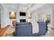 Cozy living room showcasing a white fireplace, a TV, and a comfortable blue sofa at 391 Evian Way, Mount Pleasant, SC 29464