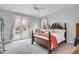 Bright main bedroom with hardwood floors, ceiling fan, french doors leading to a private balcony, and a sitting area at 391 Evian Way, Mount Pleasant, SC 29464