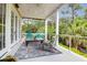Relaxing covered patio with comfortable seating, stylish rug, and French doors at 391 Evian Way, Mount Pleasant, SC 29464