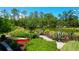 Picturesque pond view with lush landscaping and a red boat at 391 Evian Way, Mount Pleasant, SC 29464