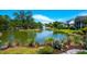 Scenic pond view with lush landscaping and charming homes in the background at 391 Evian Way, Mount Pleasant, SC 29464