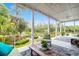Covered outdoor porch with seating, overlooking a landscaped yard and pond at 391 Evian Way, Mount Pleasant, SC 29464