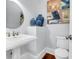 Stylish powder room with pedestal sink, decorative vases, and modern art at 391 Evian Way, Mount Pleasant, SC 29464