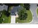 Aerial view of the house showcasing a well-maintained lawn, asphalt driveway, and mature trees at 407 Thomaston Ave, Summerville, SC 29485
