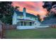 Spacious backyard with a two-story home, wooden fence, and a screened in porch with a deck at 407 Thomaston Ave, Summerville, SC 29485