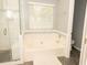 Bathroom with a tiled shower, soaking tub and window at 407 Thomaston Ave, Summerville, SC 29485