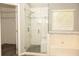 Bathroom featuring tiled glass shower, soaking tub, and large window at 407 Thomaston Ave, Summerville, SC 29485