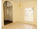 A dining room with a hanging chandelier, tile floors and a window with blinds for natural light at 407 Thomaston Ave, Summerville, SC 29485