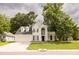 Beautiful two-story home with black roof, white siding, arched entryway, attached garage, and yard at 407 Thomaston Ave, Summerville, SC 29485